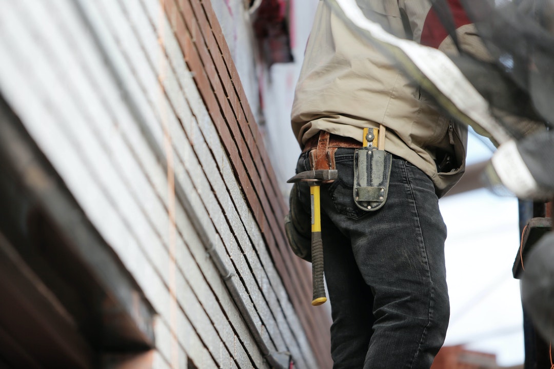 A tradesman wearing a tool belt